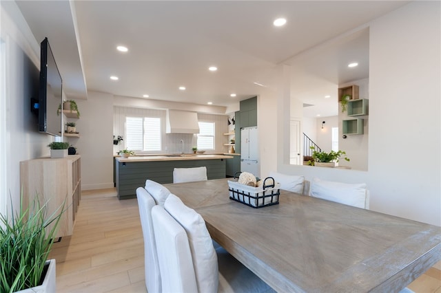 dining space with light hardwood / wood-style flooring and sink