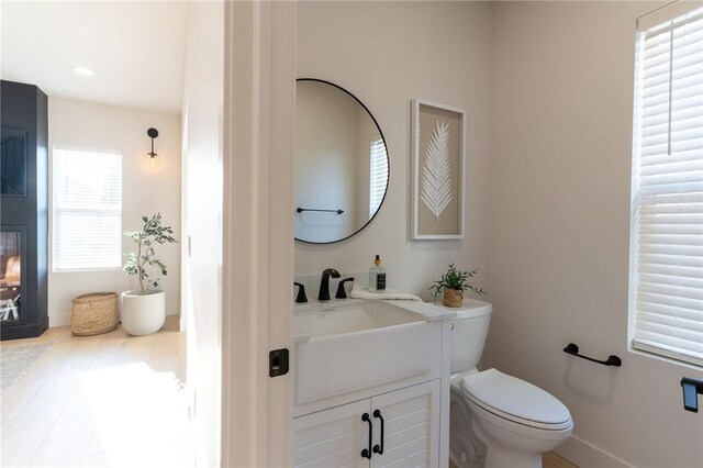 bathroom featuring tile patterned flooring, toilet, and vanity