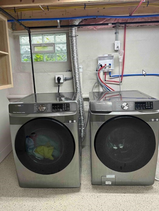 clothes washing area featuring washer and dryer