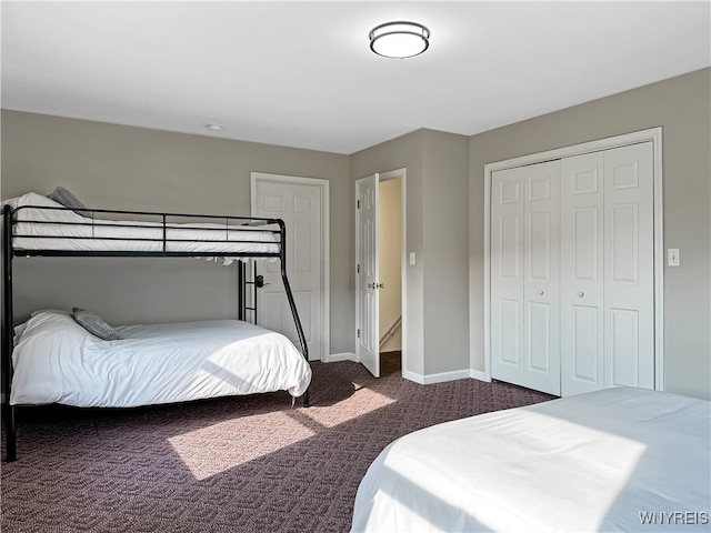 bedroom featuring dark carpet and a closet