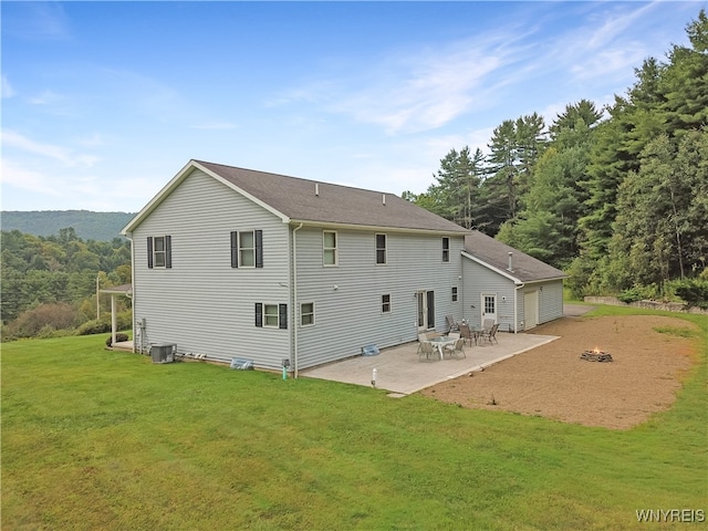 back of property featuring a lawn, a patio area, and central AC unit