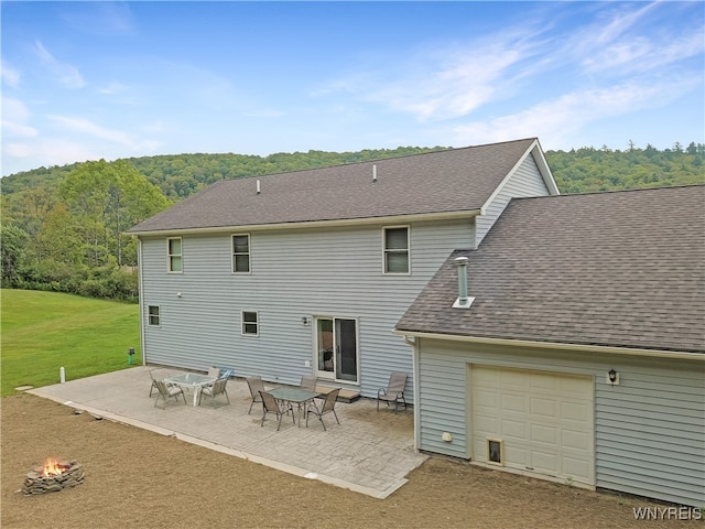 rear view of house with a yard and a patio