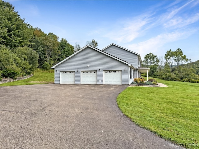 view of property exterior with a yard and a garage