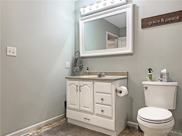 bathroom featuring vanity and toilet