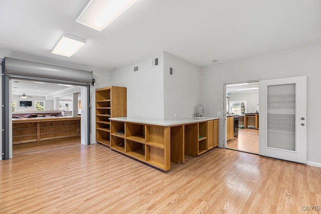 kitchen featuring light hardwood / wood-style flooring, sink, and ceiling fan