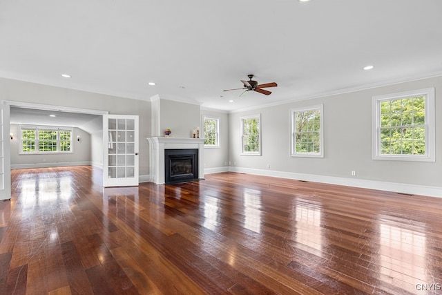 unfurnished living room with ceiling fan, dark hardwood / wood-style floors, and crown molding