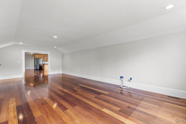 bonus room with lofted ceiling and dark hardwood / wood-style floors