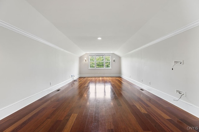 additional living space featuring lofted ceiling and dark hardwood / wood-style floors