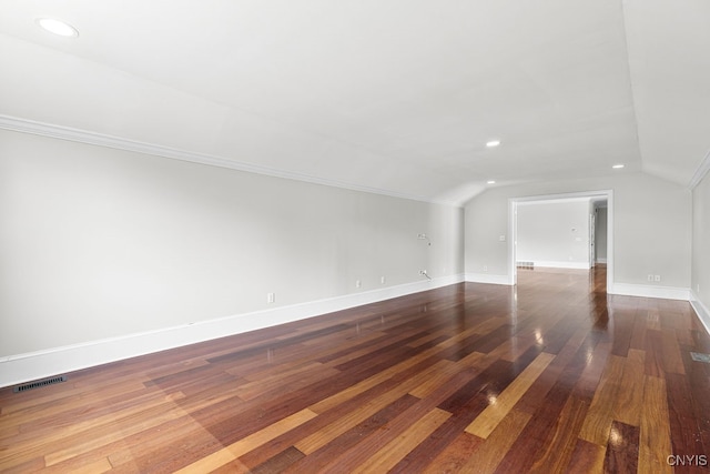 bonus room with hardwood / wood-style floors and vaulted ceiling