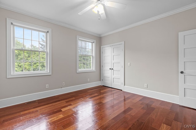 spare room with ornamental molding, dark wood-type flooring, and ceiling fan