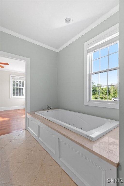 bathroom with ornamental molding, a bathing tub, and tile patterned floors