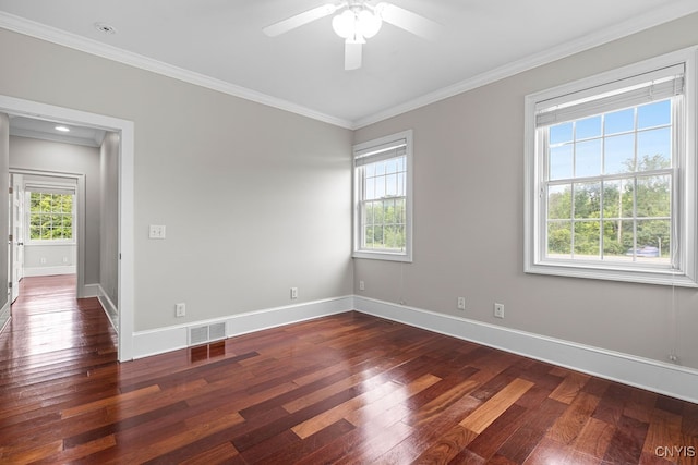 unfurnished room with a wealth of natural light, dark wood-type flooring, ceiling fan, and ornamental molding