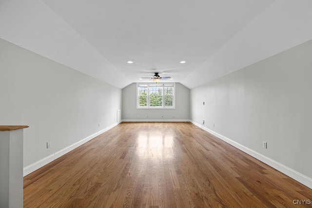 additional living space with dark wood-type flooring and lofted ceiling