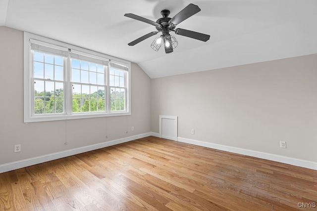 unfurnished room with light hardwood / wood-style flooring, ceiling fan, and vaulted ceiling