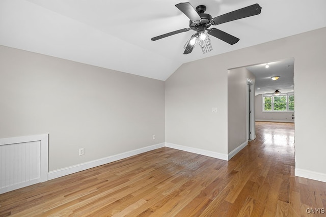 unfurnished room with light hardwood / wood-style flooring, ceiling fan, and vaulted ceiling