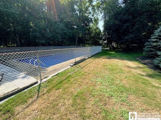 view of pool featuring a yard