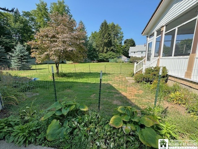 view of yard with a sunroom