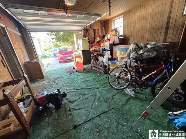 garage featuring wood walls