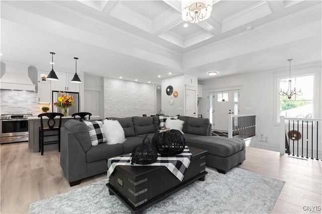 living room featuring coffered ceiling, a notable chandelier, beam ceiling, light hardwood / wood-style floors, and crown molding