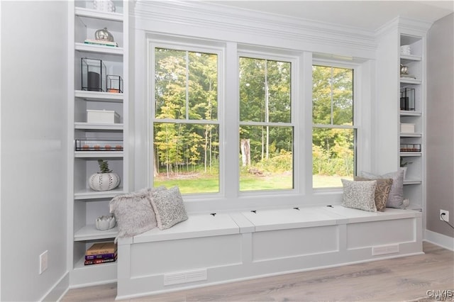 sitting room featuring hardwood / wood-style flooring and a healthy amount of sunlight