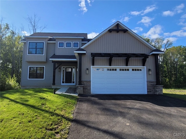 view of front of house featuring a garage and a front lawn