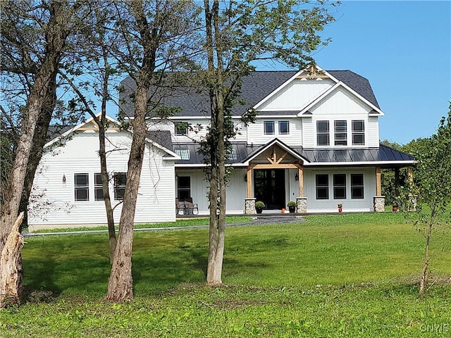 view of front of property with a porch and a front lawn