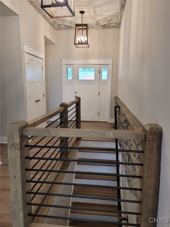 entrance foyer with hardwood / wood-style flooring and an inviting chandelier