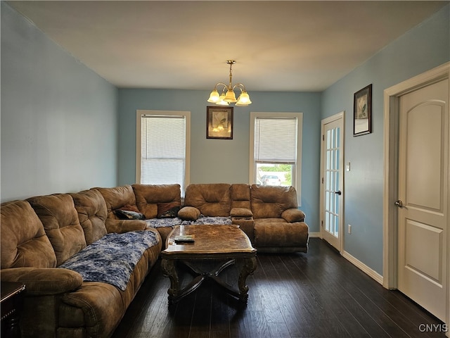 living room with dark hardwood / wood-style floors and a chandelier