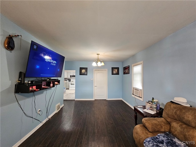 living room with cooling unit, hardwood / wood-style floors, and a chandelier