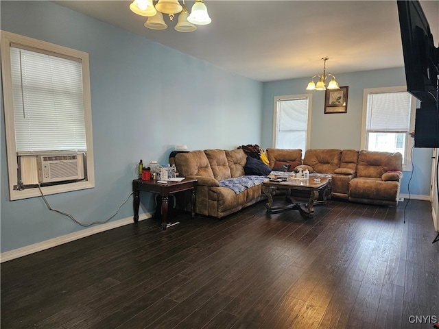 living room with dark wood-type flooring, cooling unit, and a chandelier