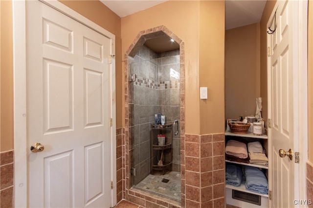 bathroom featuring tile walls and walk in shower