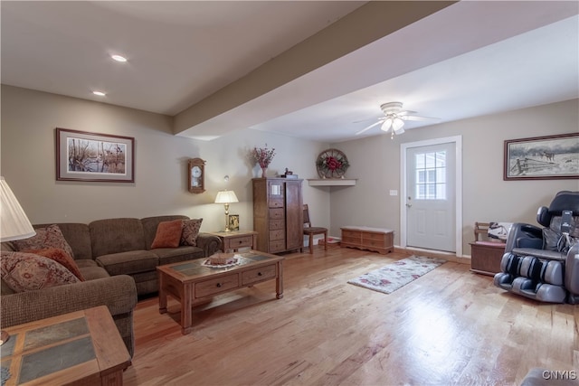 living room with ceiling fan and light hardwood / wood-style floors