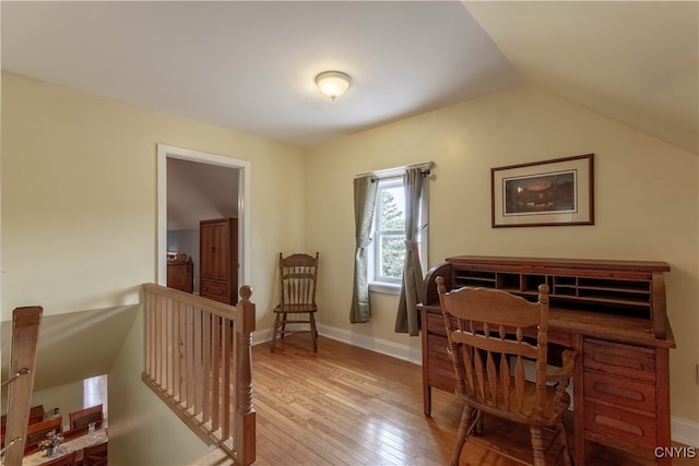 office space featuring light hardwood / wood-style floors and vaulted ceiling