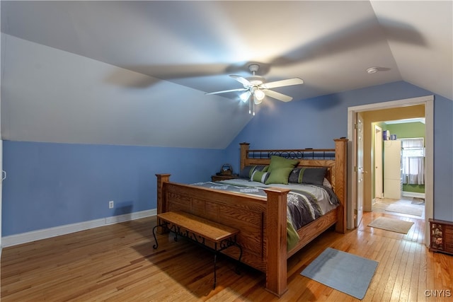 bedroom with ceiling fan, vaulted ceiling, and light hardwood / wood-style flooring