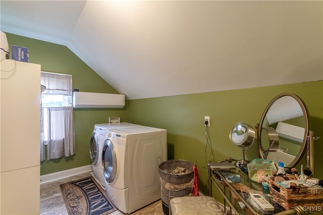 laundry room with an AC wall unit and washer and dryer