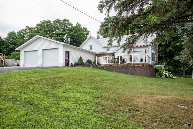 view of front of house with an outdoor structure, a garage, and a front lawn