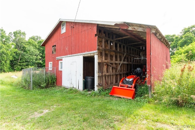 view of outbuilding featuring a lawn