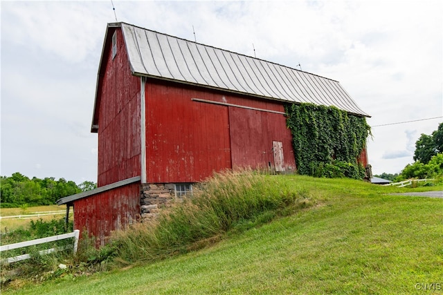 view of outbuilding featuring a yard