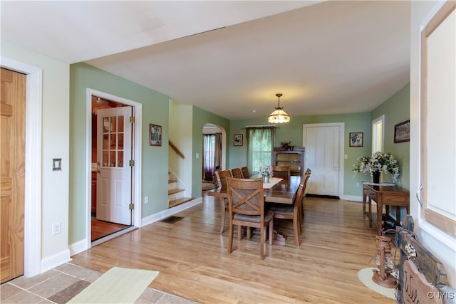 dining room featuring hardwood / wood-style floors and a notable chandelier