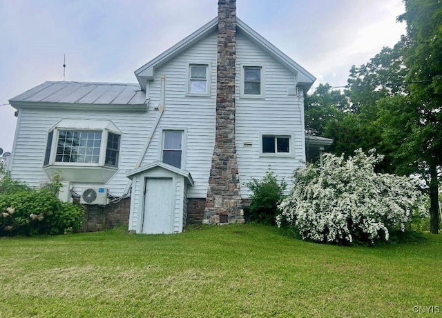 318 Stevens Rd, Gouverneur, NY 13642 - rear view of house featuring a standing seam roof, a yard, and a metal roof