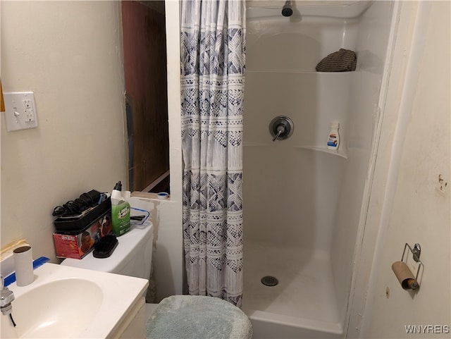 bathroom featuring vanity and curtained shower