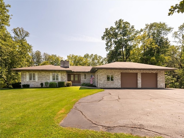 single story home with a garage and a front yard