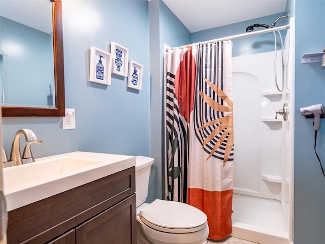 bathroom featuring vanity, toilet, and curtained shower