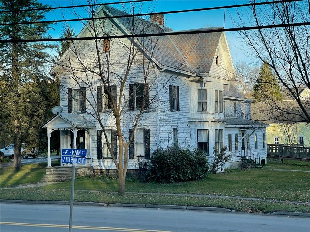 view of front of property featuring a front lawn and a chimney