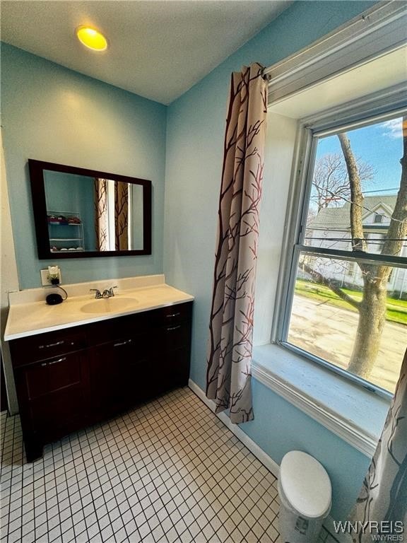 bathroom with tile patterned flooring and vanity