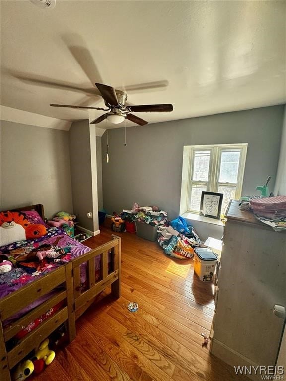 bedroom with ceiling fan and hardwood / wood-style flooring