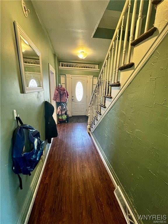 doorway to outside featuring dark wood-type flooring