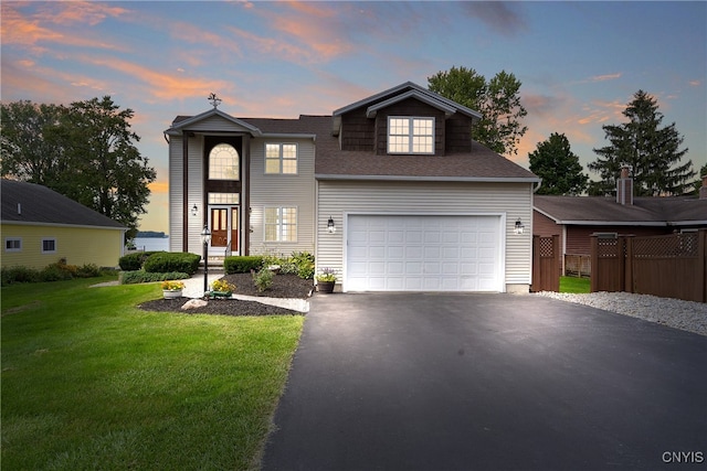 view of front of home featuring a yard and a garage