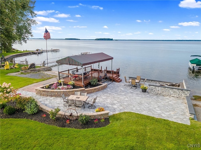 exterior space featuring a water view, a yard, and a patio area