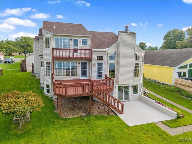 back of house featuring a yard, stairway, a wooden deck, a chimney, and a patio area